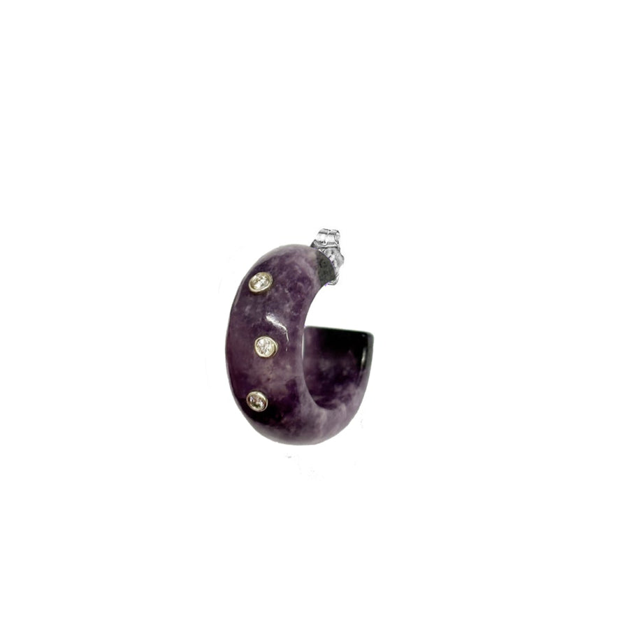 Purple earring with embedded stones on a white background